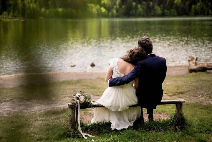 Bride and groom sitting on a bench