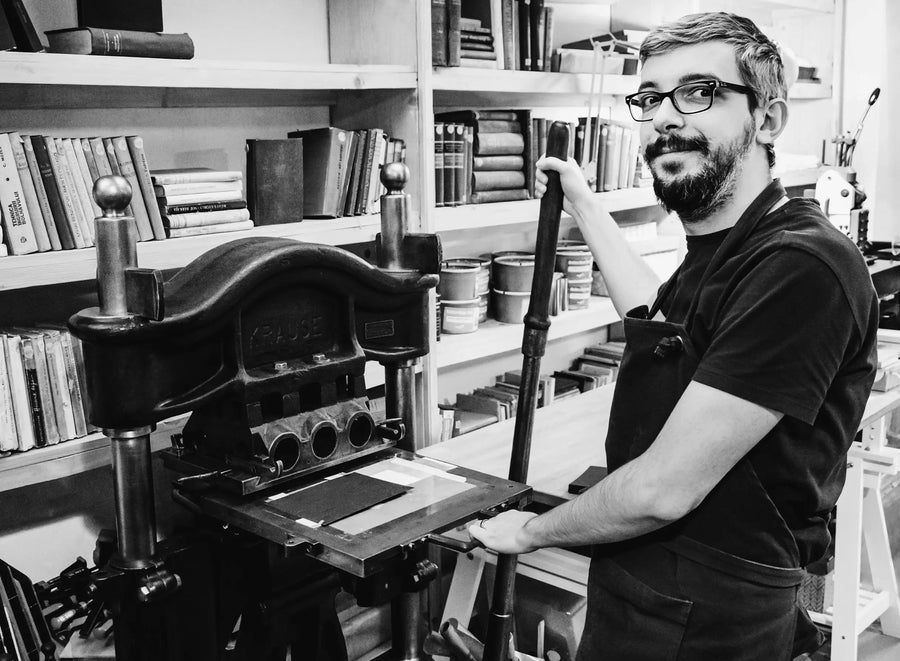 Black and white picture of a man in a letterpress studio