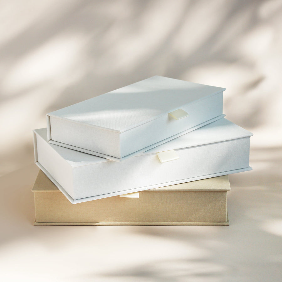 Stacked handcrafted linen covered photo boxes