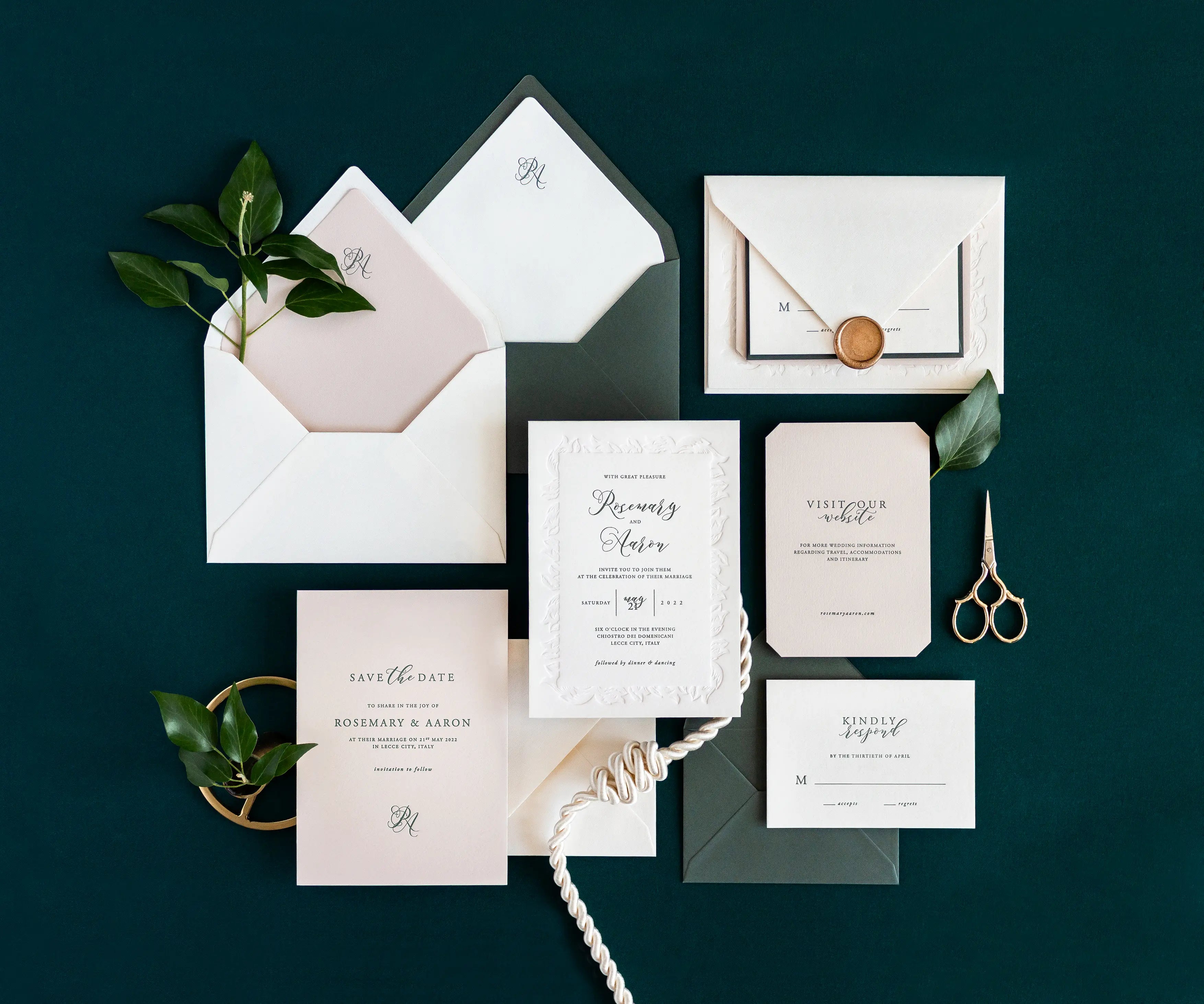 Top view of acanthus themed letterpress wedding invitation set and envelopes