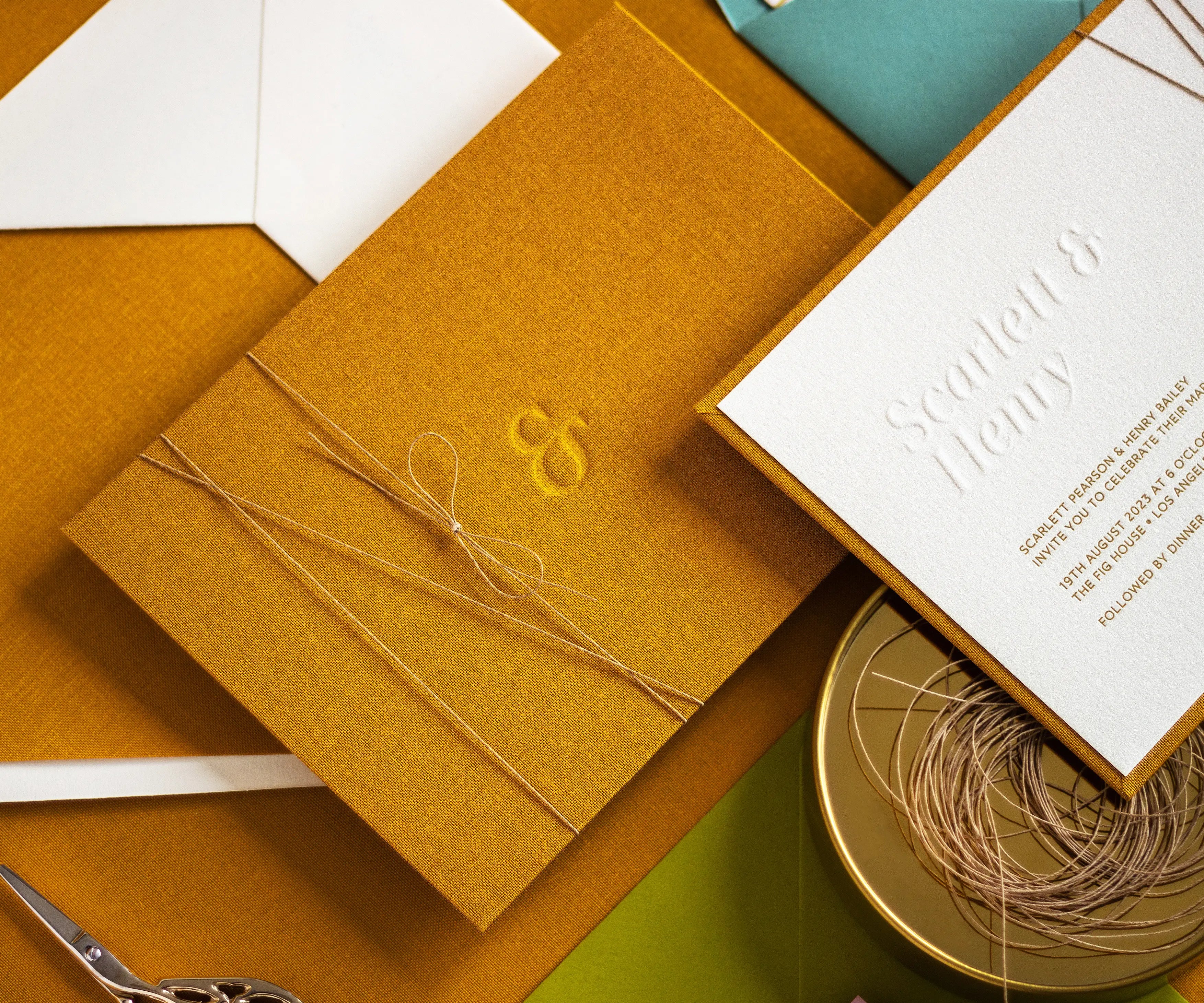 Linen backing of a wedding invitation with blind letterpress ampersand