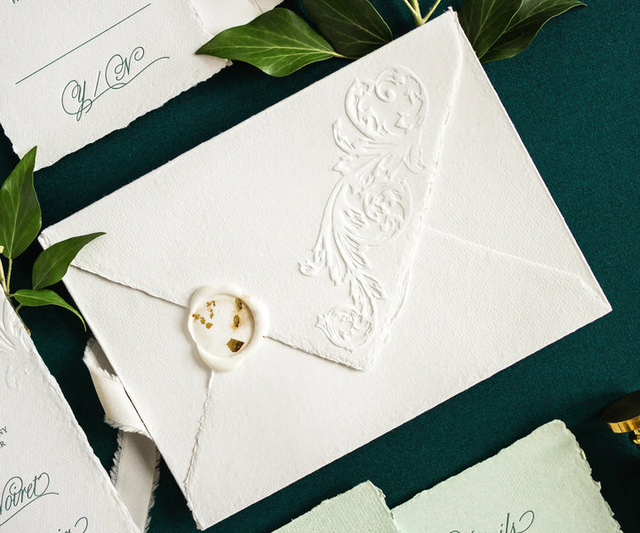 Handmade paper envelope with wax seal and blind emboss acanthus leaf illustration