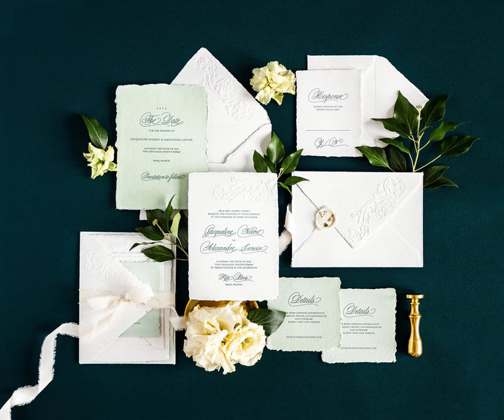 Top view of letterpress wedding invitation set and envelopes