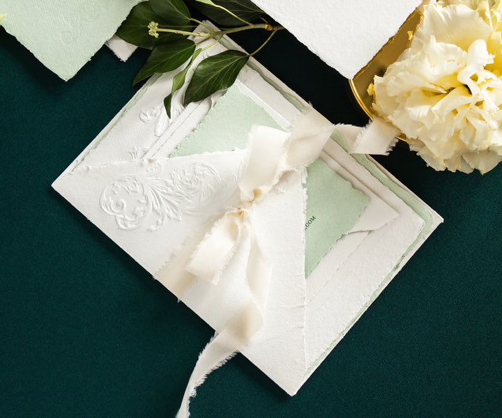 Letterpress wedding invitation set tied with silk ribbon