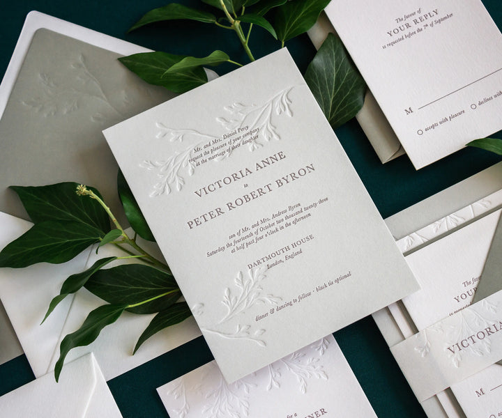Letterpress wedding invitation with ivy branch illustration