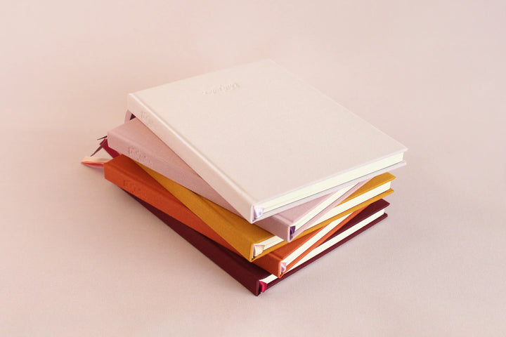 Stacked linen covered journals