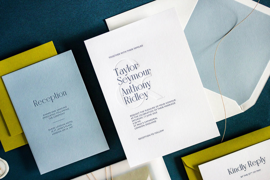 Envelope and letterpress wedding invitation with blind ampersand