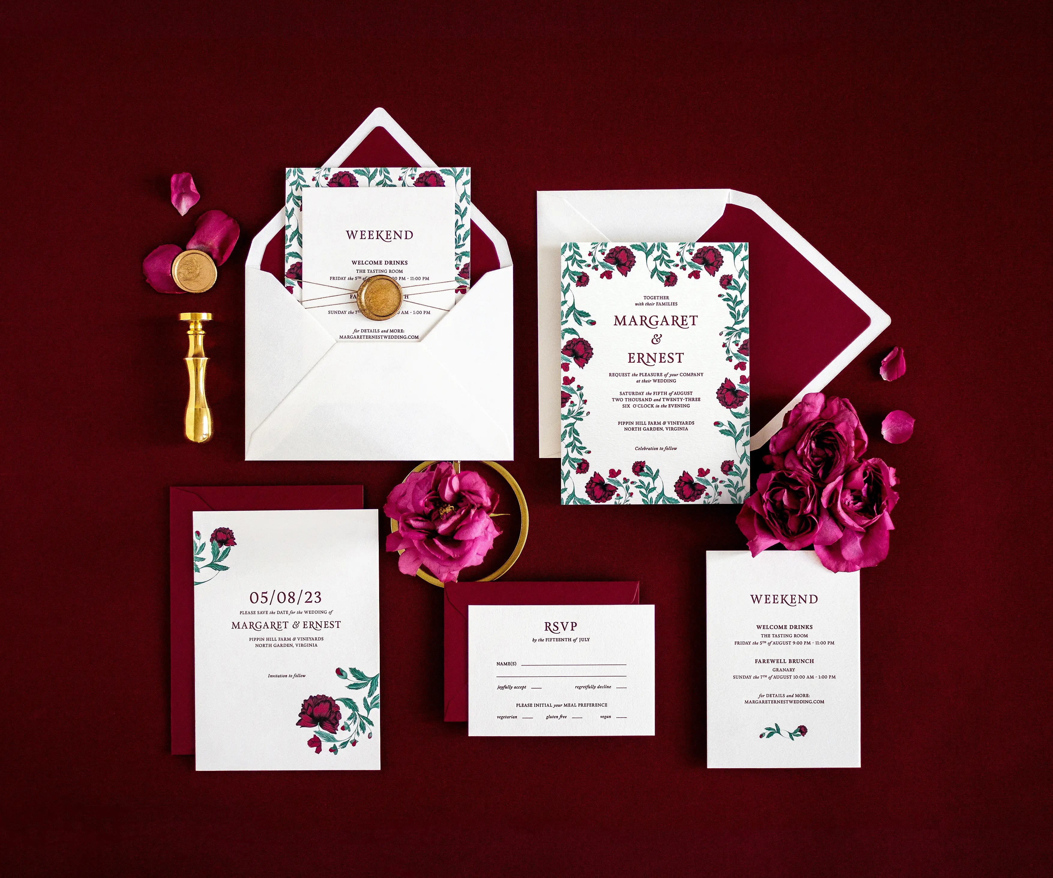 Top view of poppy themed letterpress wedding invitation set and envelopes