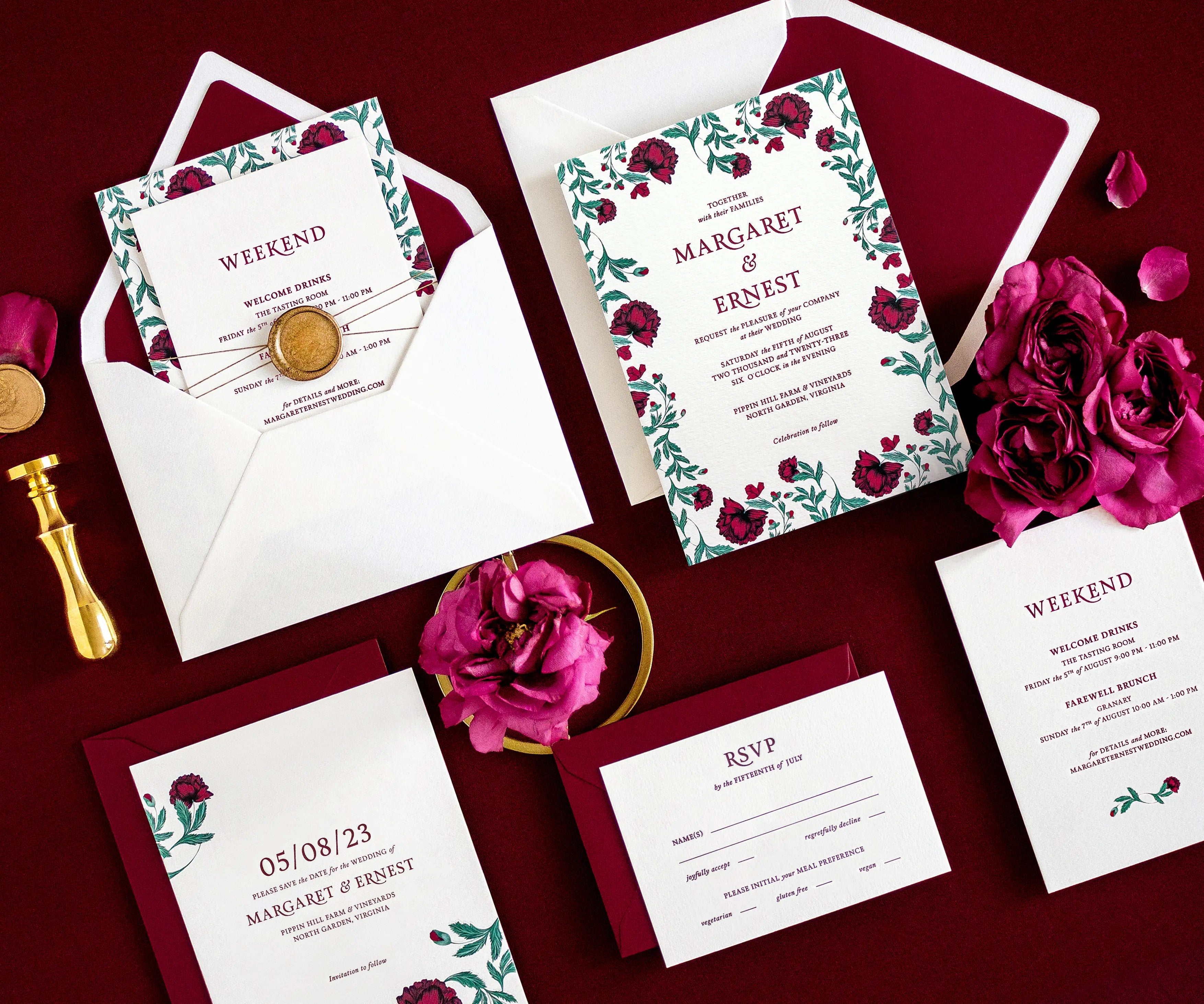 Angled top view of poppy themed letterpress wedding invitation set and envelopes