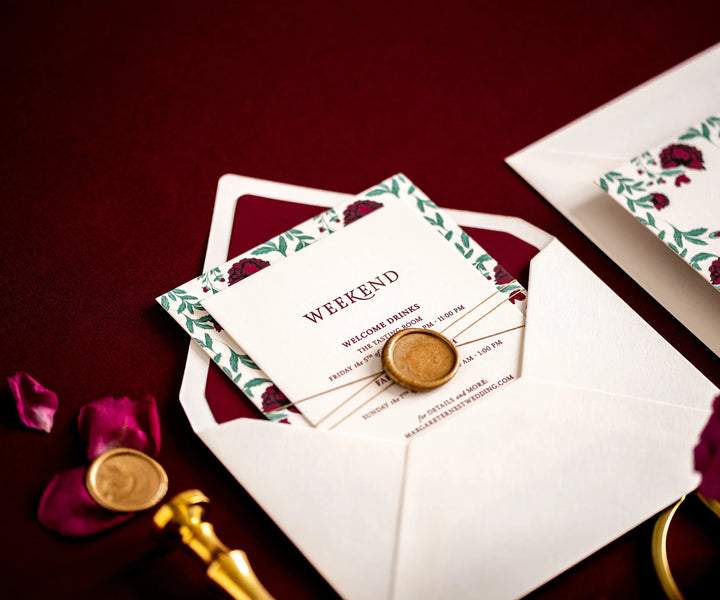 Letterpress wedding invitation set with wax seal in an open envelope