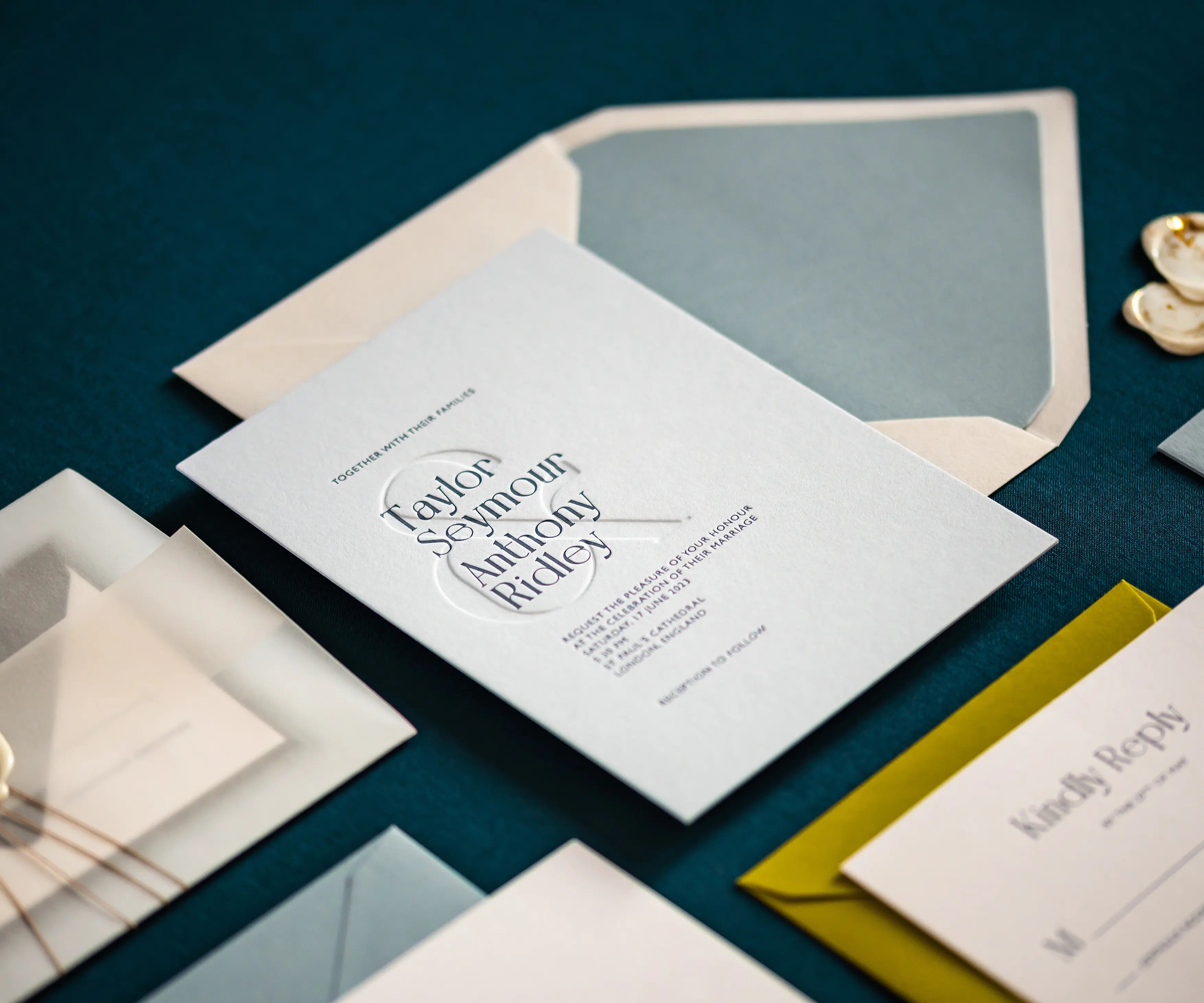 Envelope and letterpress wedding invitation with blind ampersand