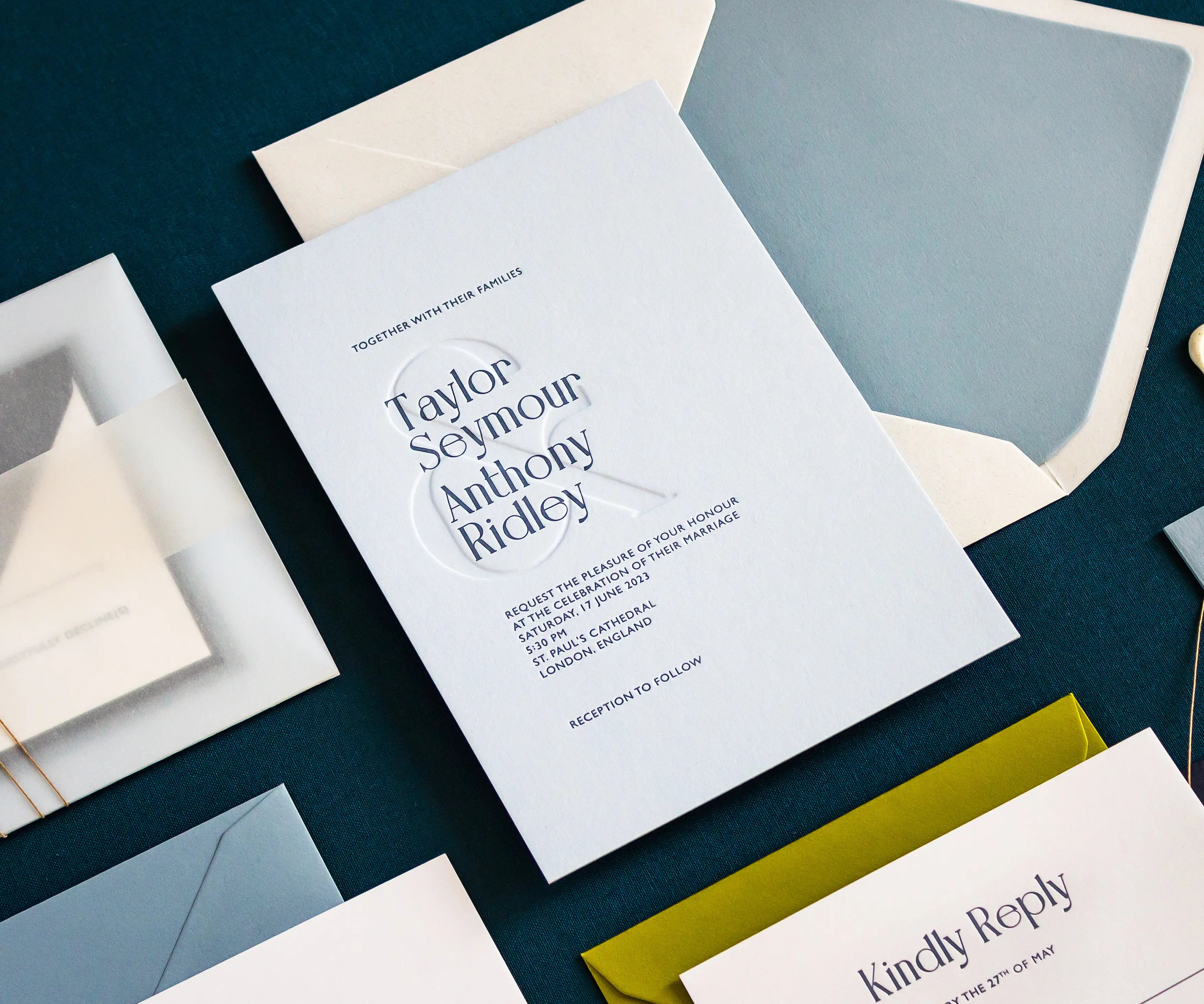 Envelope and letterpress wedding invitation with blind ampersand