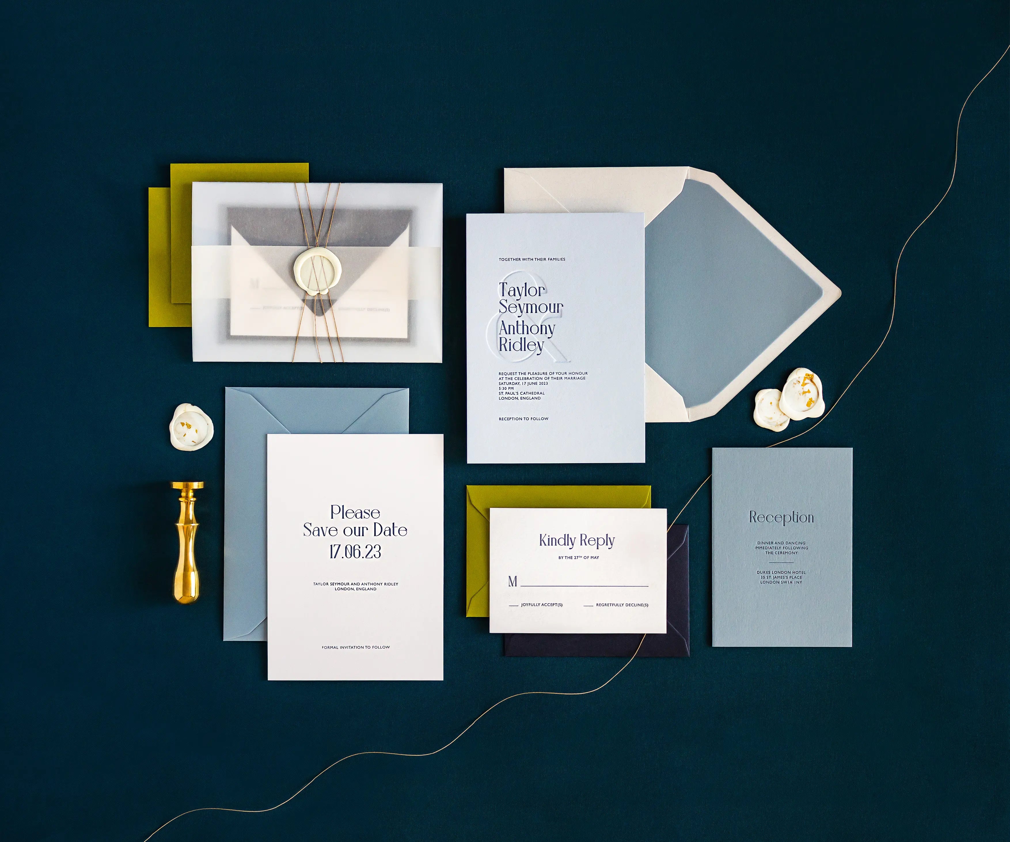 Top view of sunset themed letterpress wedding invitation set and envelopes