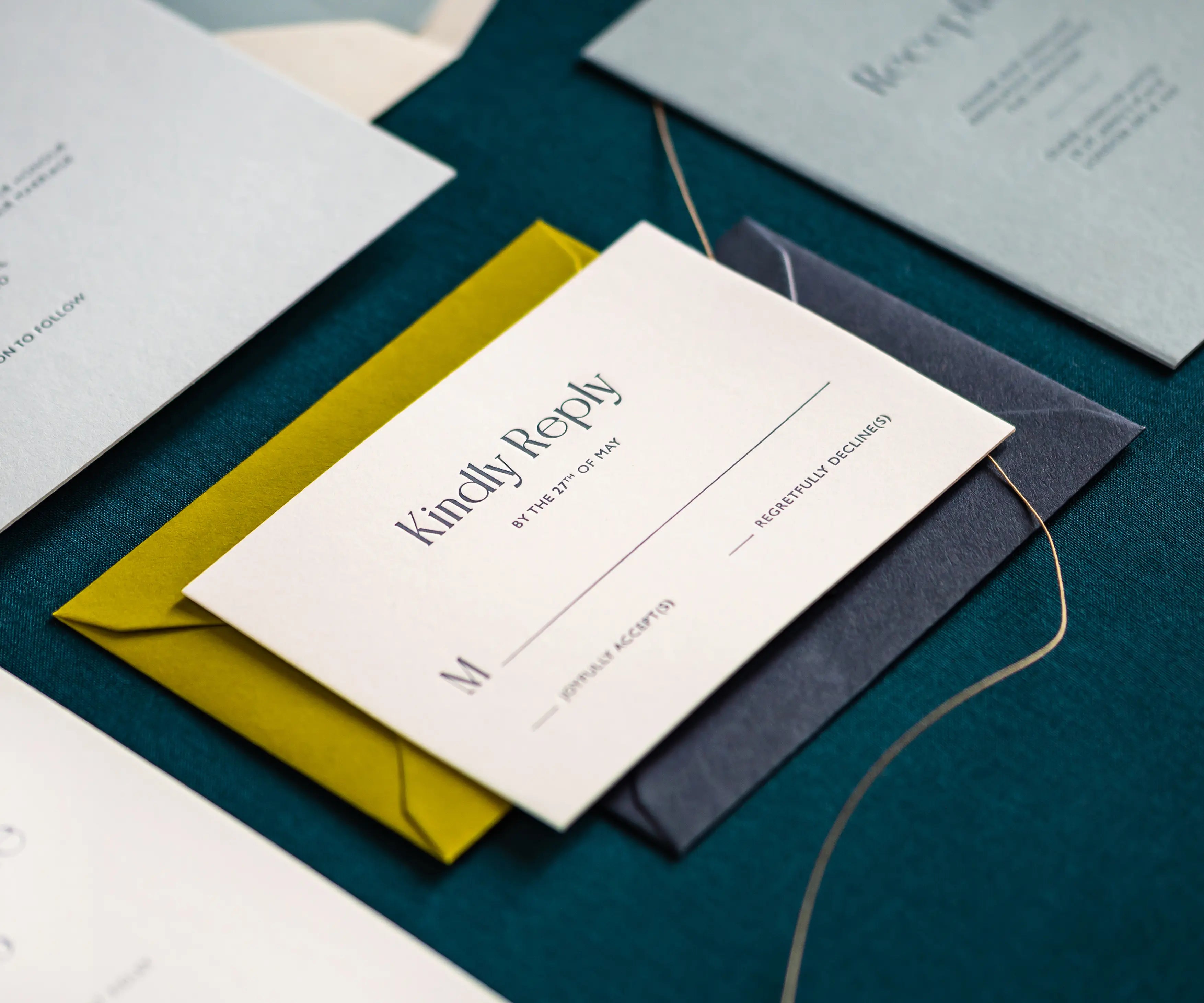 Letterpress RSVP card on green envelope