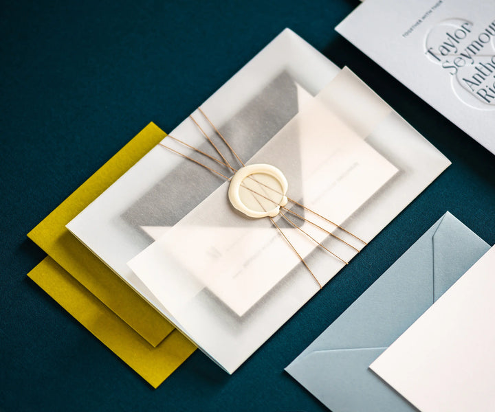 Letterpress invitation set wrapped in vellum