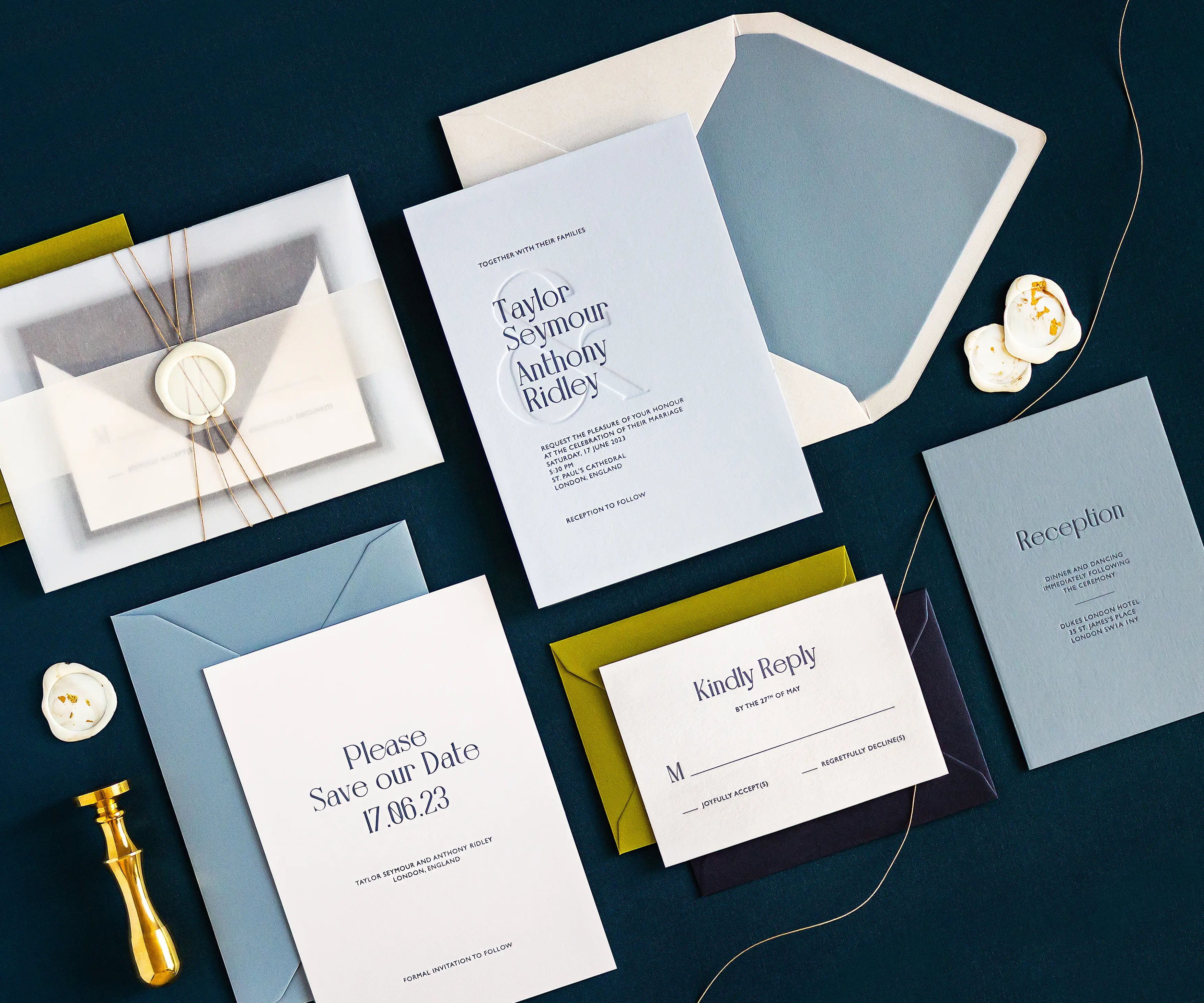 Angled top view of sunset themed letterpress wedding invitation set and envelopes