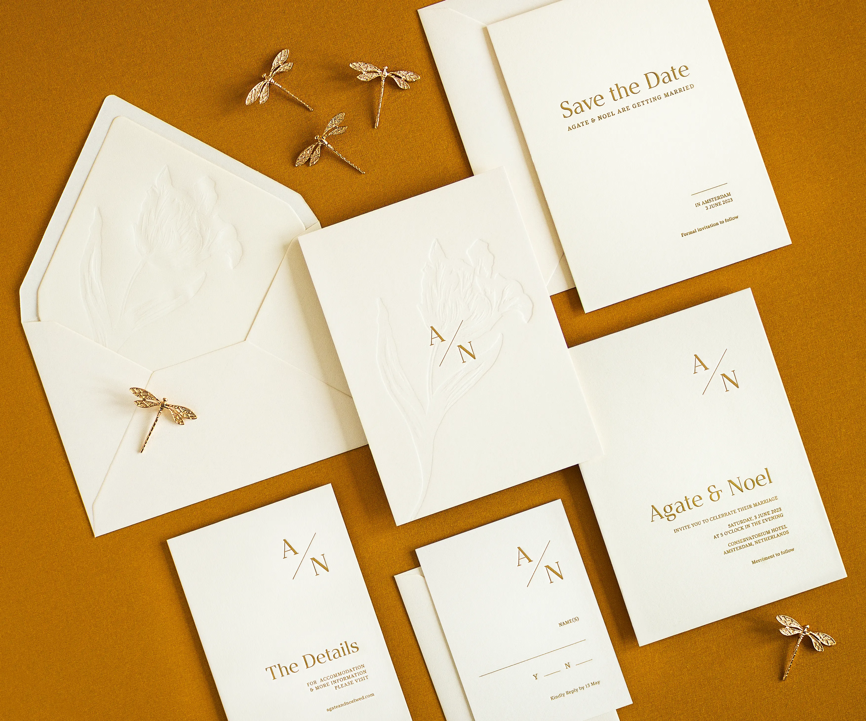 Angled top view of tulip themed letterpress wedding invitation set and envelopes