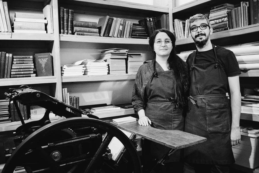 Black and white picture of a couple in a letterpress studio