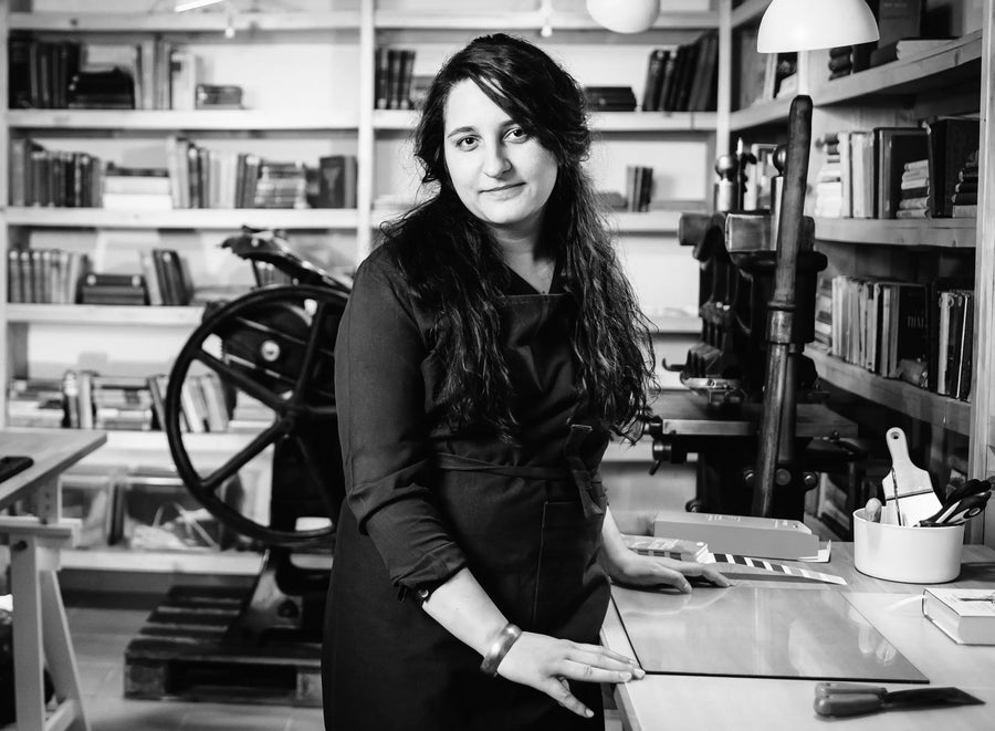 Black and white picture of a woman in a letterpress studio